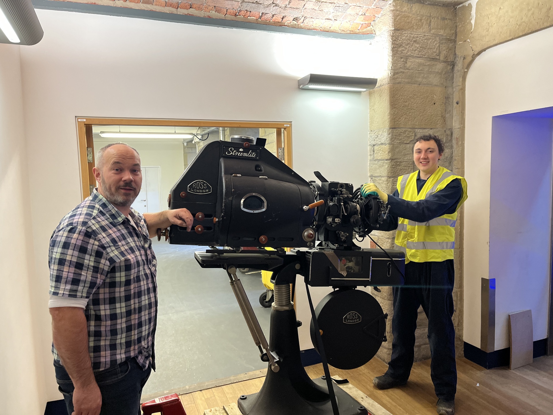 PPT Curator Alex Cooper, and PPT member Jacob Pearson, moving a Ross projector.